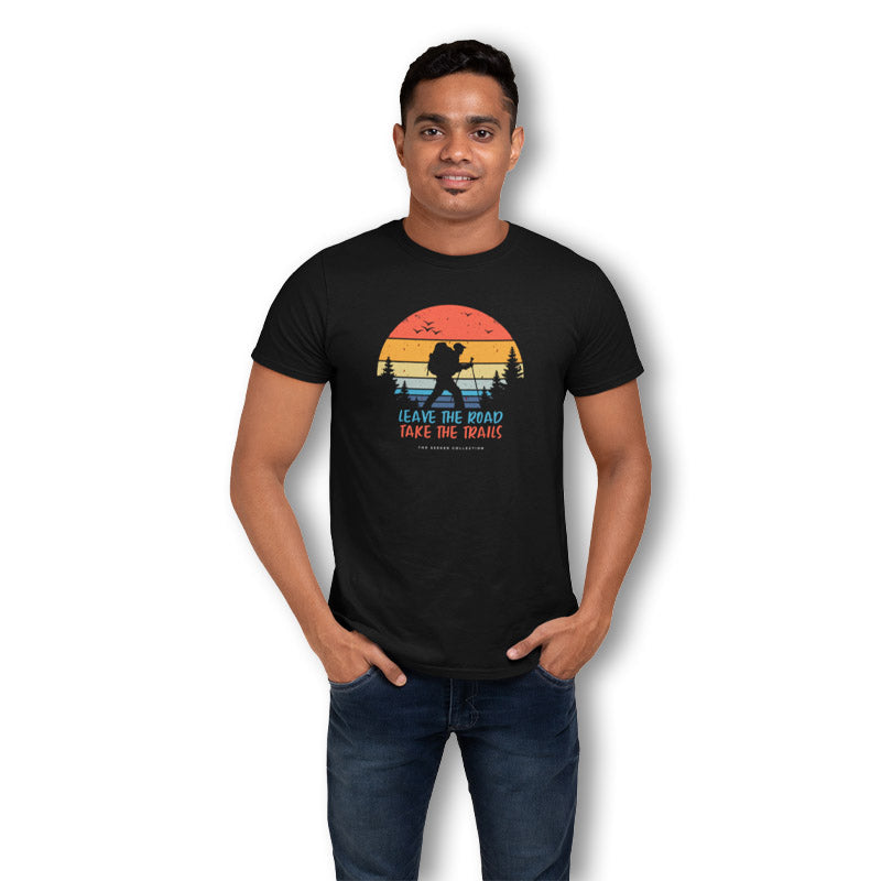 Black men's T-shirt from The Mahua Store with a leave roads and take trails print design.