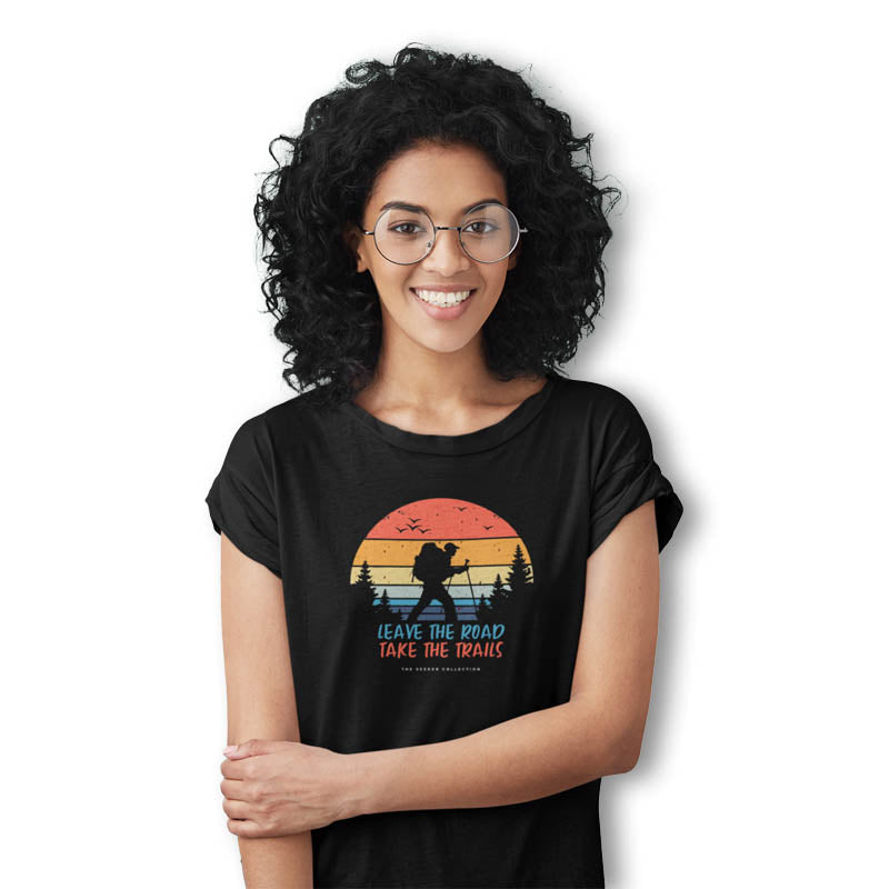 Black women's T-shirt from The Mahua Store with a "Leave Roads-Take Trails" print, casual and comfortable everyday wear.