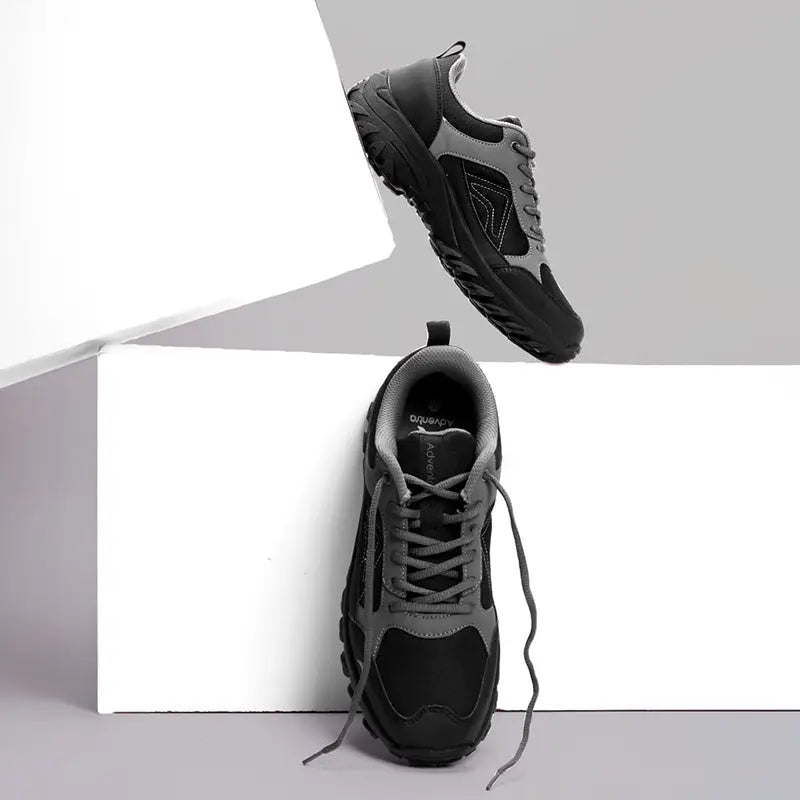 Adventra men's low ankle hiking shoes in gray and black with rugged soles and supportive design for outdoor adventures.