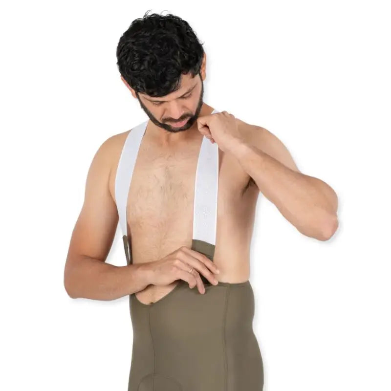 Apace men's cycling endurance bib shorts in moss green, with padded design and adjustable straps for comfortable riding.
