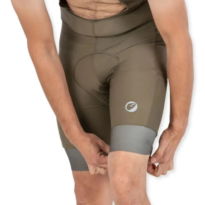 Apace men's cycling endurance bib shorts in moss green, featuring padded chamois and breathable fabric for comfortable riding.