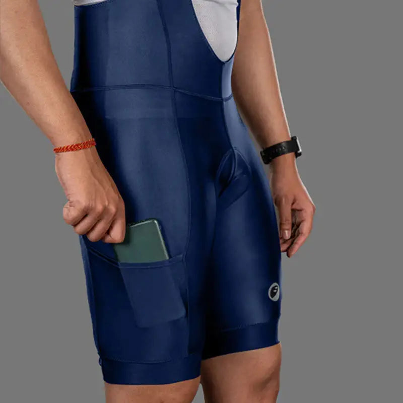 Apace men's Explore cycling bib shorts in navy, featuring padded chamois and adjustable straps for comfortable biking.