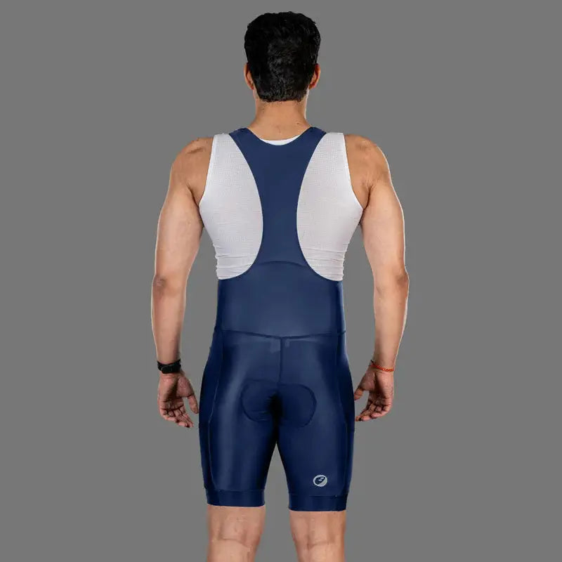 Apace men's Explore cycling bib shorts in navy, featuring padded compression fit and adjustable shoulder straps for cycling comfort.