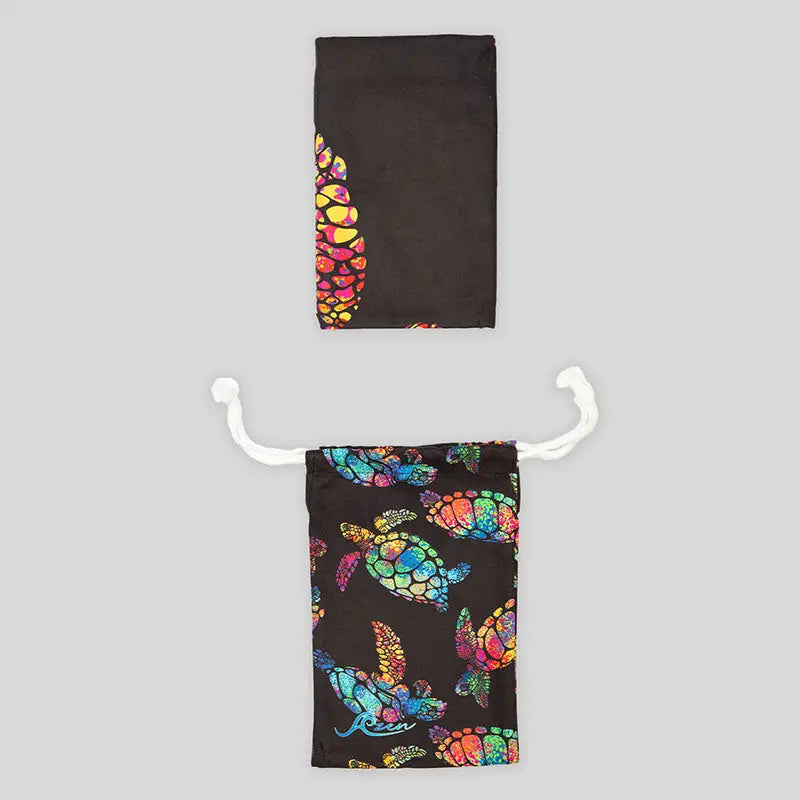 Black Azen unisex microfiber beach towel laid flat, showcasing its soft, lightweight fabric and versatile design for beach and outdoor use.