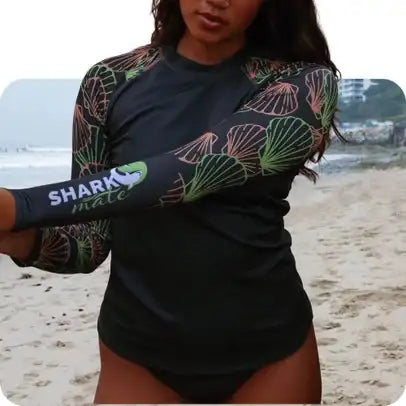 Black shark mate arm sleeve with a vibrant green and pink seashell pattern.