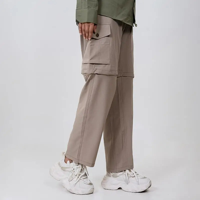 Clawear Women's Kuno convertible cargo pants in black, featuring multiple pockets and adjustable cuffs for versatile wear.