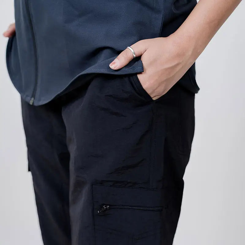 Black Clawear Women's Masai Cargo Pants with multiple pockets, relaxed fit, and adjustable waistband, styled for casual wear.