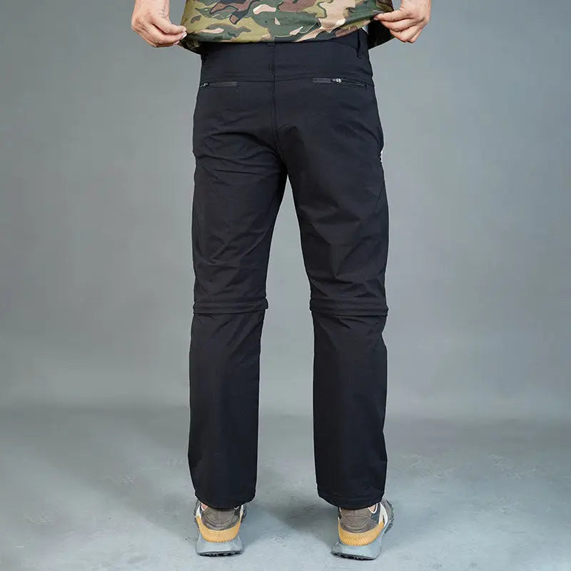 Black JAG Men's Delta 2.0 convertible trekking and hiking cargo pants with six functional pockets, suitable for outdoor adventures.