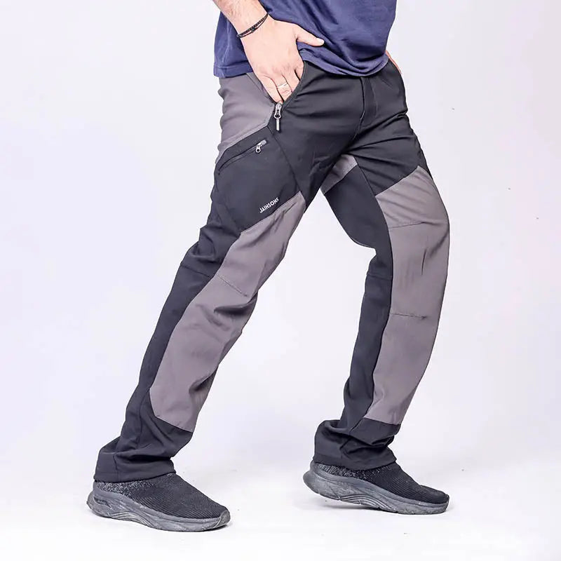 JAG Men's Tactical Pro Series hiking and trekking cargo pants with multiple pockets, durable fabric, and adjustable waist for outdoor adventures.