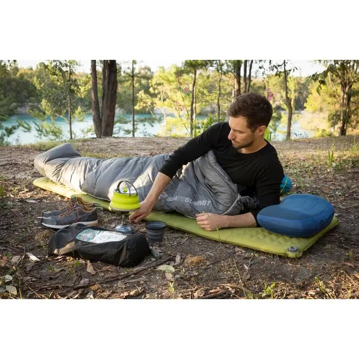 Sea to Summit Camp Self-Inflating Sleeping Mat in green, regular size, showcasing its compact, cushioned design for outdoor sleeping comfort.