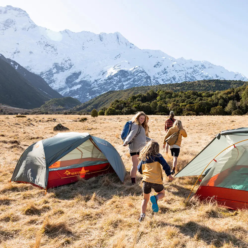 Sea to Summit Ikos TR3 three-person tent set up outdoors with grey fabric and waterproof rainfly, showing its spacious interior and sturdy poles.