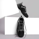 Adventra men's low ankle hiking shoes in gray and black with rugged soles and supportive design for outdoor adventures.