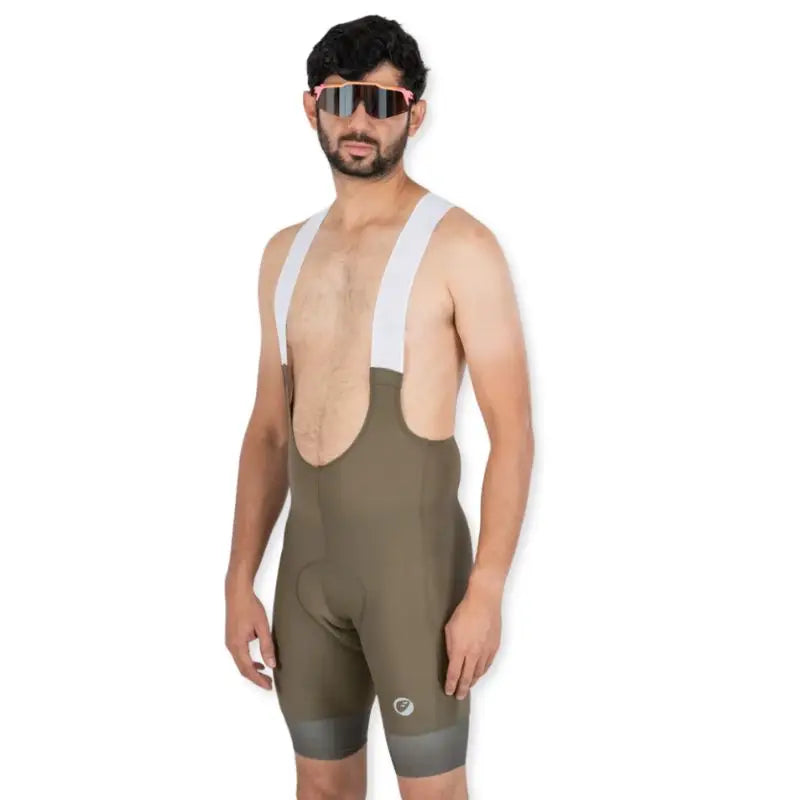 Apace men's cycling endurance bib shorts in moss green, featuring padded chamois and adjustable straps for comfortable riding.