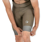 Apace men's cycling endurance bib shorts in moss green, featuring padded chamois and breathable fabric for comfortable riding.