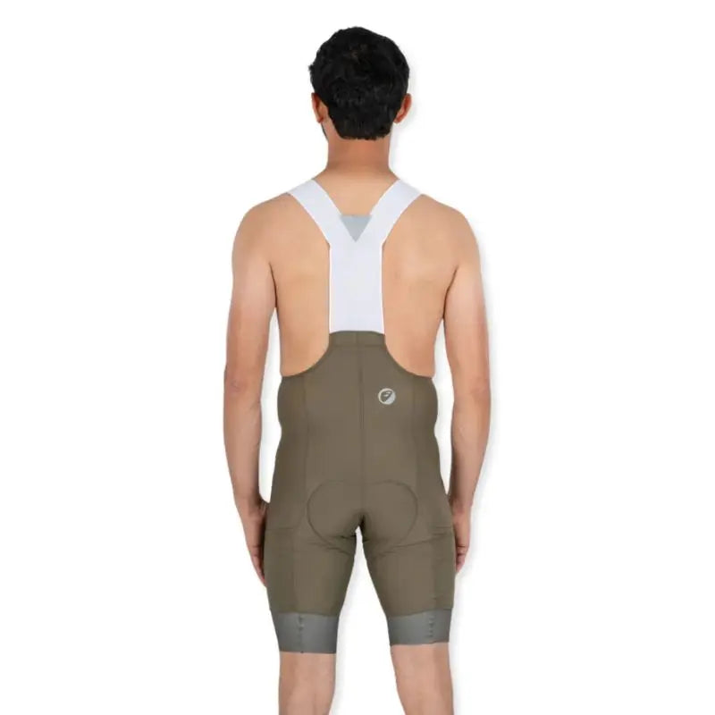 Apace men's cycling endurance bib shorts with moss green fabric, featuring padded chamois and adjustable straps for comfort.