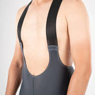 Apace men's cycling endurance bib shorts in slate gray with breathable fabric and padded chamois for comfortable long rides.
