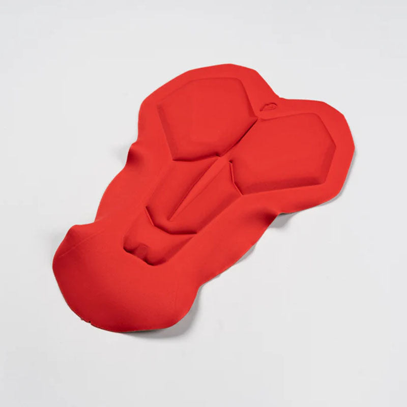 A male cyclist wearing navy Apace Explore cycling bib shorts, with padded seat and adjustable straps, on a scenic trail.