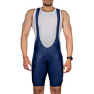 Apace men's Explore cycling bib shorts in navy, featuring padded chamois, breathable fabric, and adjustable straps for comfort.