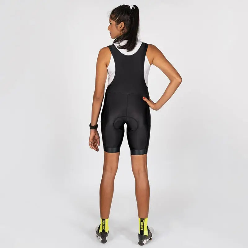 Apace women's cycling bib shorts shown on a model, featuring breathable fabric and adjustable straps for comfortable biking.