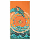 Azen unisex microfiber beach towel with colorful striped pattern laid flat on sandy shore.