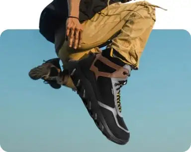 Black and tan hiking boot with rugged sole, featuring a durable synthetic upper and visible lacing system.