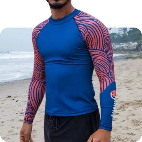 Blue and red patterned long-sleeve rash guard with a shark logo on the sleeve.