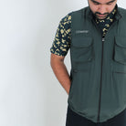 Clawear Mens Corbett 2.0 vest jacket in green with front zipper and padded design, shown on a hanger.