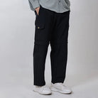 Black Clawear Kuno convertible cargo pants for men, featuring multiple pockets and adjustable straps, shown on a model.