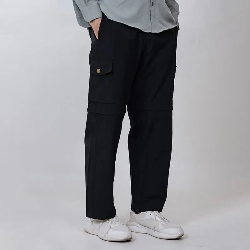 Black Clawear Kuno convertible cargo pants for men, featuring multiple pockets and adjustable straps, shown on a model.