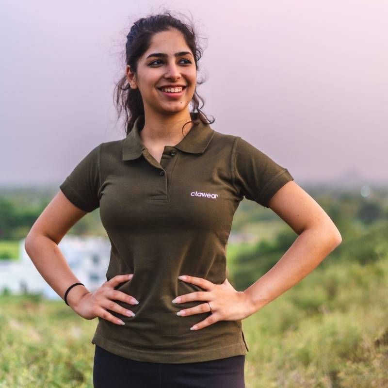 Green Clawear Women's Jawai Polo T-shirt displayed on a hanger, showcasing the casual design and lightweight fabric.