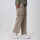 Clawear Women's Kuno convertible cargo pants in black, featuring multiple pockets and adjustable cuffs for versatile wear.