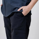 Black Clawear Women's Masai Cargo Pants with multiple pockets, relaxed fit, and adjustable waistband, styled for casual wear.