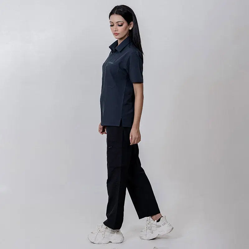 Black Clawear Women's Masai Cargo Pants with multiple pockets and relaxed fit, styled for casual wear.