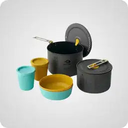 The image shows a compact, multi-piece camping cookware set with black and yellow components.