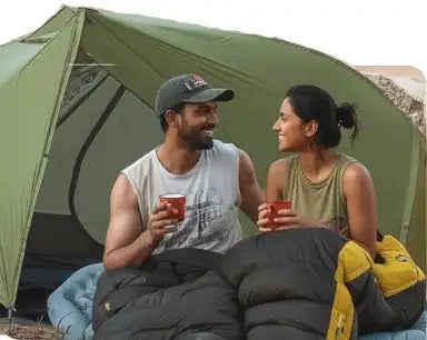 A green tent with a curved, arched entrance and visible guy lines.