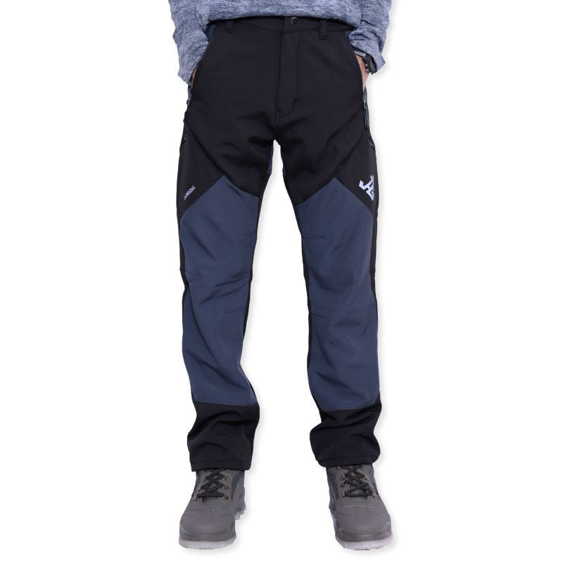 Black JAG men's snow proof trekking pants from the Mt. Kailash series with multiple cargo pockets, designed for hiking and outdoor activities.