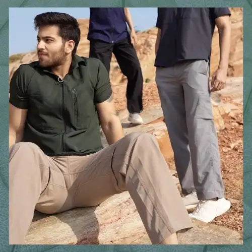 A man wearing a dark green short-sleeved button-up shirt and beige cargo pants.