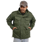 Men's olive green NLTW utility jacket with box pockets, featuring a rugged design and multiple front storage compartments.