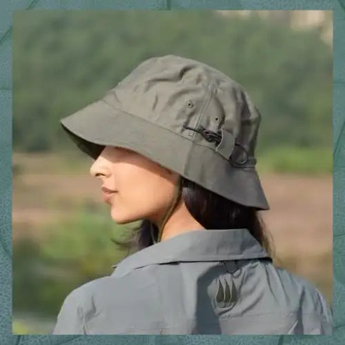 Olive green bucket hat with adjustable strap and button closure