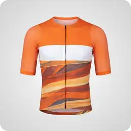 Orange and white short-sleeved cycling jersey with a desert-like pattern.
