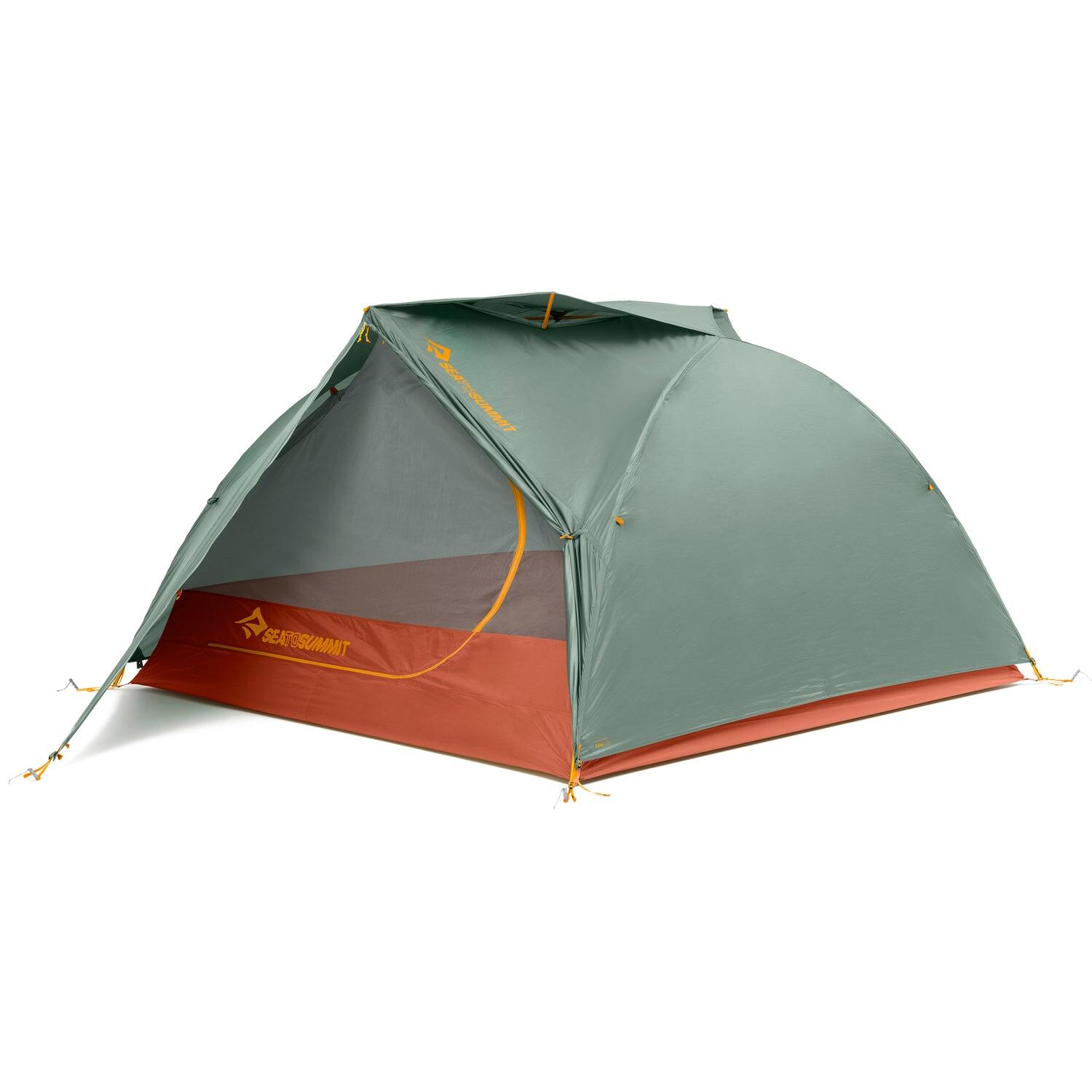 Three-person Sea to Summit Ikos TR3 tent set up outdoors, featuring gray fabric, rainfly, and mesh windows for ventilation.