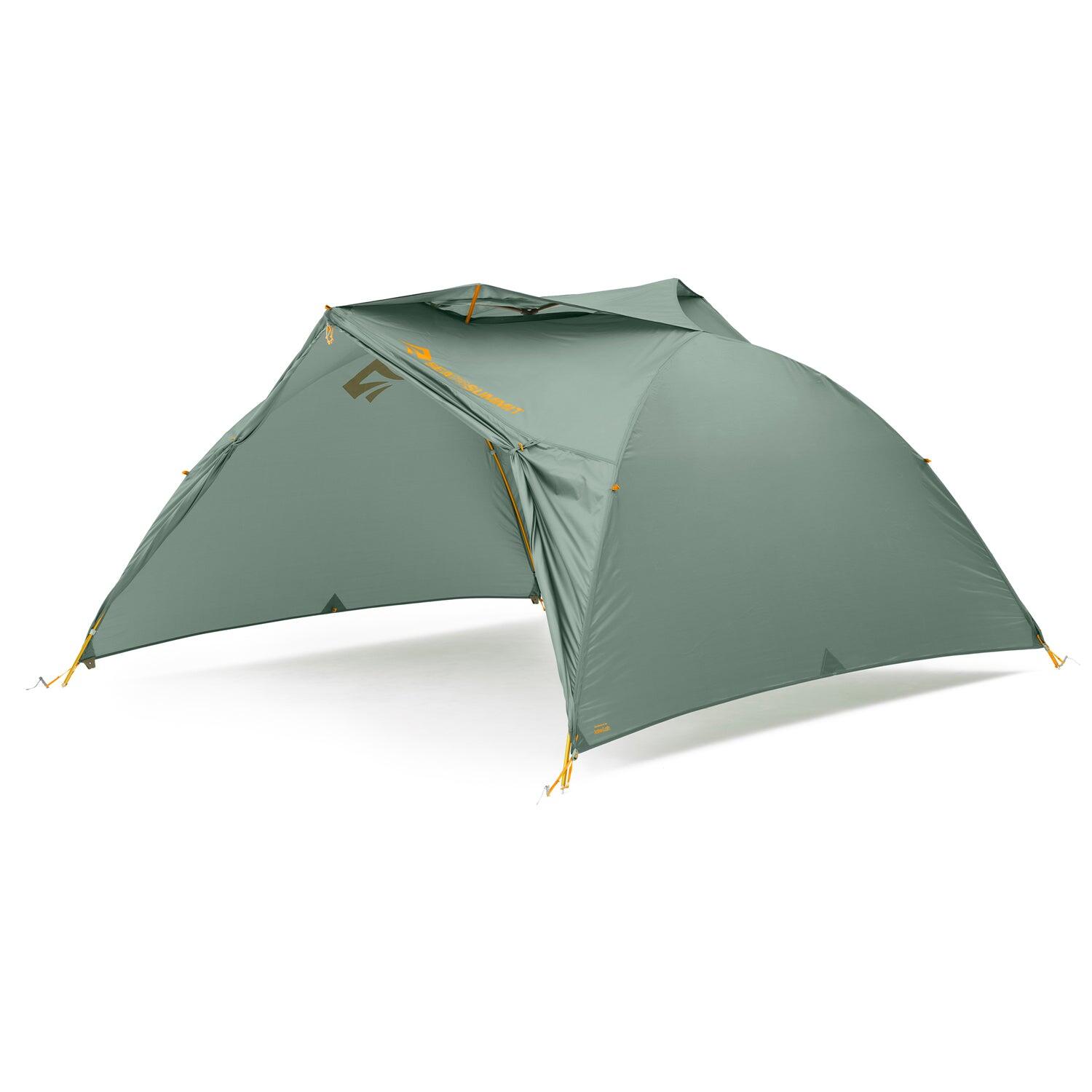 Sea to Summit Ikos TR3 three-person tent set up outdoors, showcasing lightweight, durable camping tent with gray fabric and rainfly.