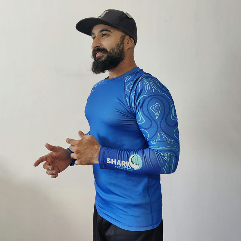 Juvenile angel fish swimming near a Shark Mate men's water sports UV rash guard T-shirt, full sleeve design, suitable for water activities.