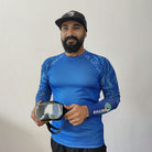 Juvenile angel fish swimming with a Shark Mate men's water sports UV rash guard T-shirt in the background.