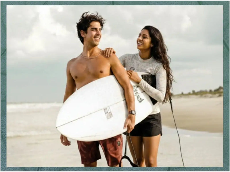 White surfboard with a sleek, glossy finish and subtle branding decals.